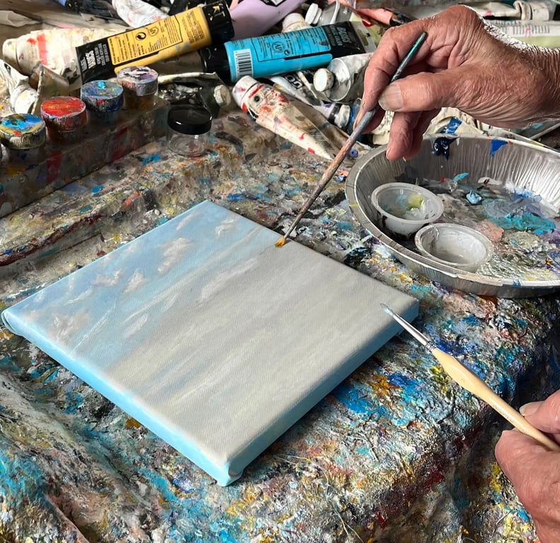 Ralph Reed painting a Sky Diary artwork on canvas.